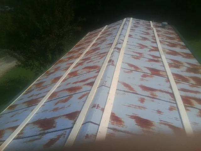 Rusted metal roof panels with new wood purlins before replacement — Storm Damage Roof Repair in Jefferson by Roofing Brothers